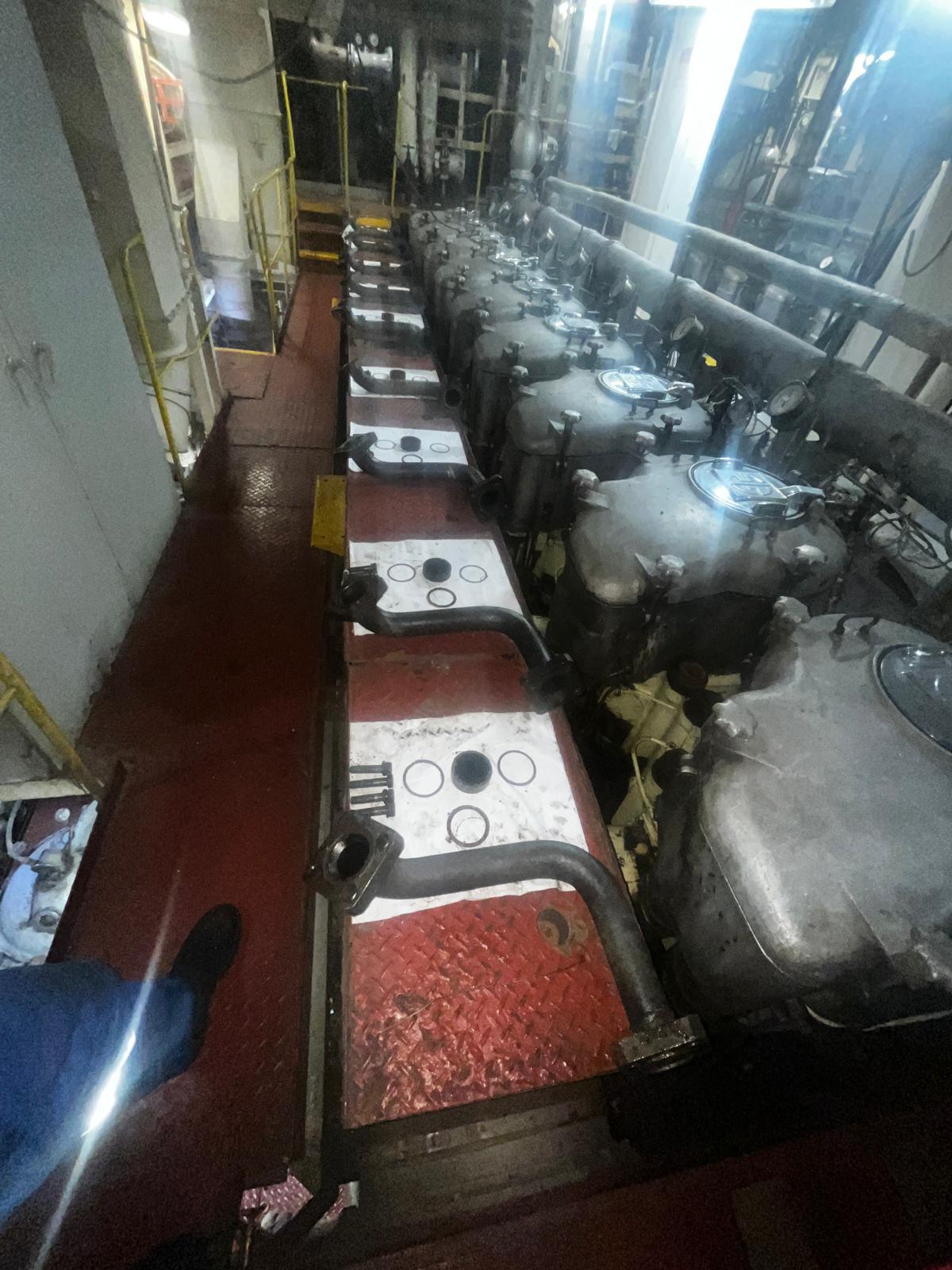 Engine parts and seals laid out beside the main engine